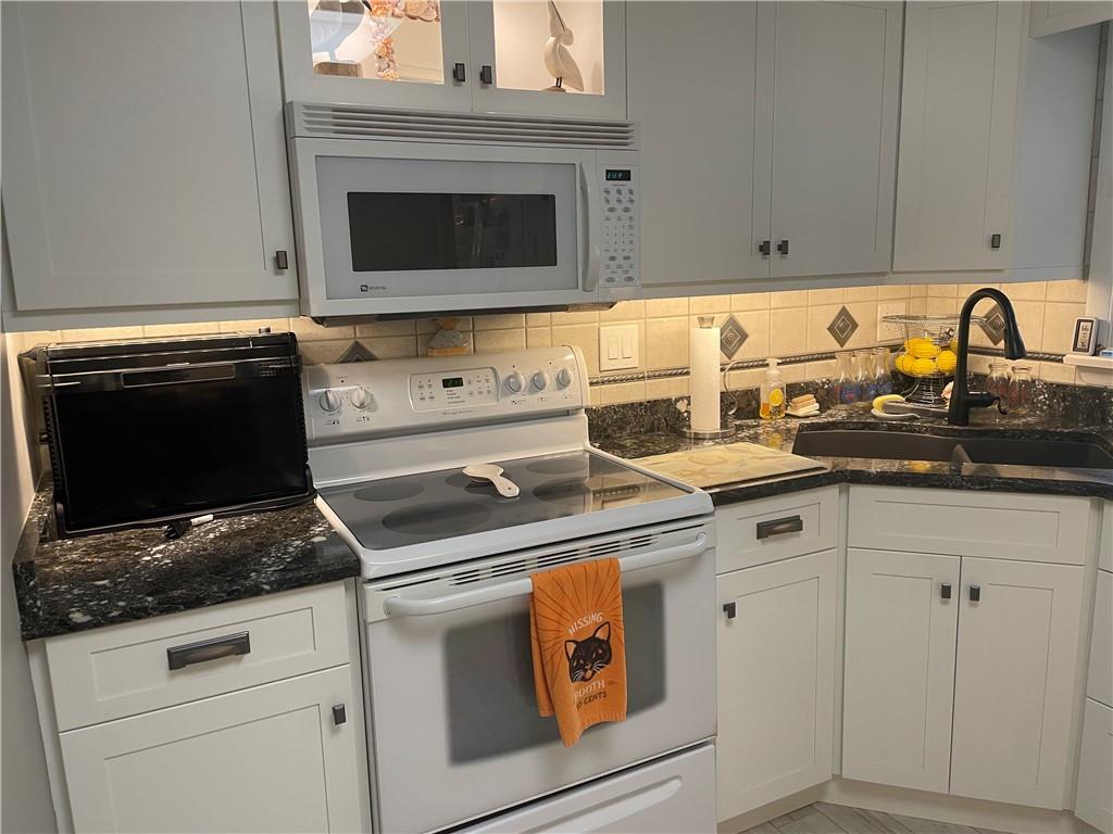 313 Pine Drive New Stanton, PA 15672 - Photo 13 of 41 a white stove top oven sitting inside of a kitchen