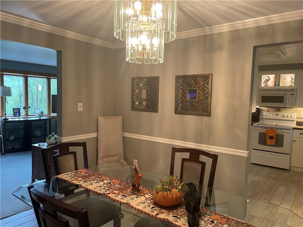 313 Pine Drive New Stanton, PA 15672 - Photo 18 of 41 a view of a dining room with furniture and chandelier