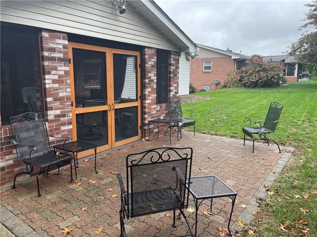 313 Pine Drive New Stanton, PA 15672 - Photo 7 of 41 a view of a patio with a table and chairs