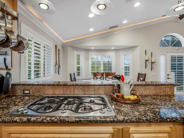 a kitchen with sink a stove and cabinets