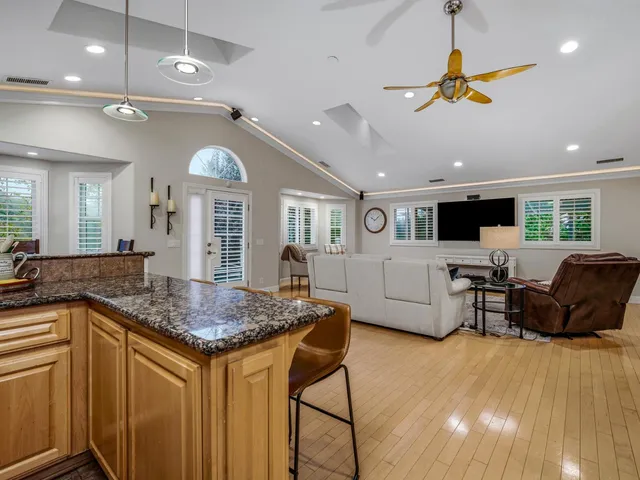 a living room with furniture and kitchen view