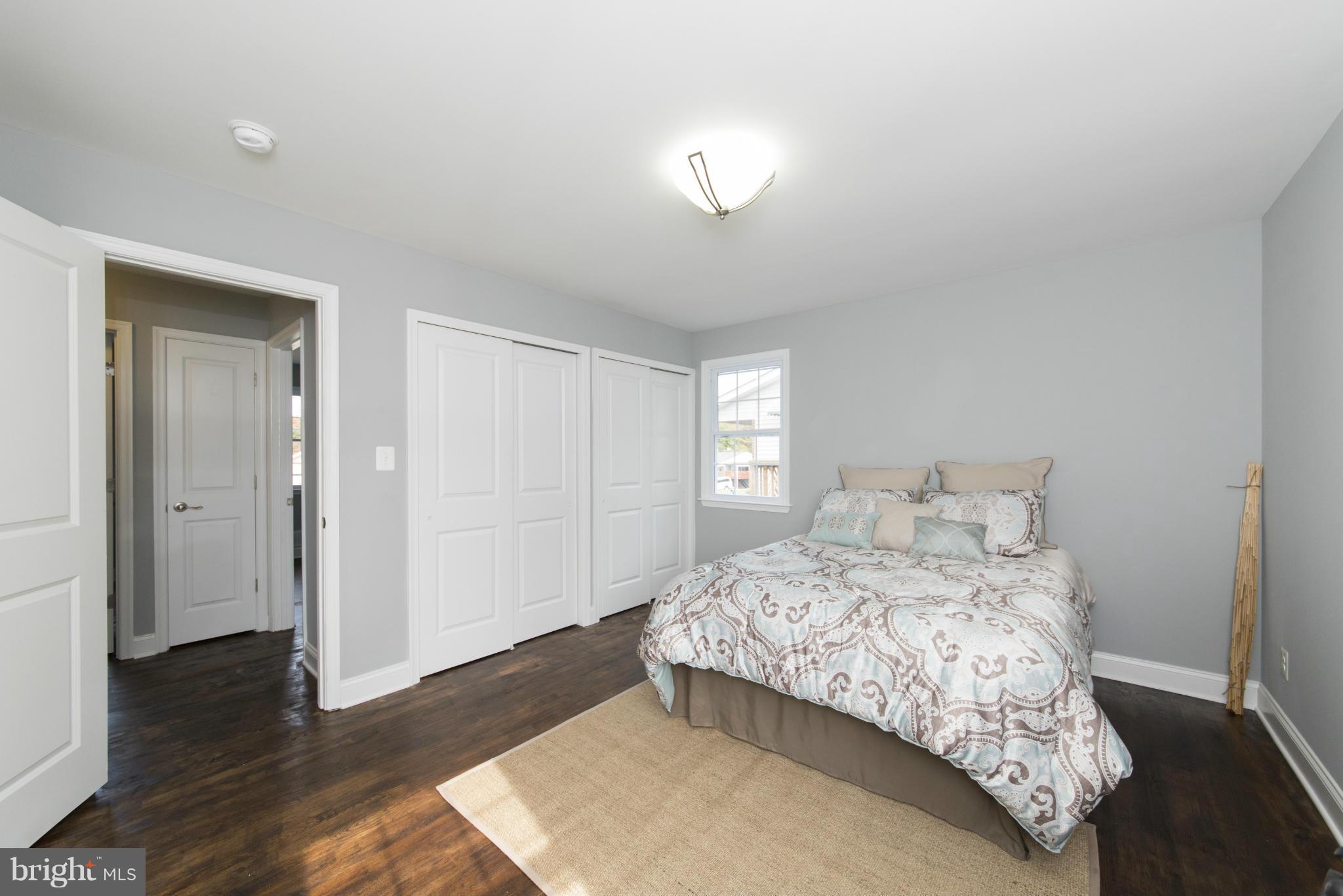 6705 Fordcrest Road Baltimore, MD 21237 - Photo 16 of 30 a bedroom with a bed and wooden floor