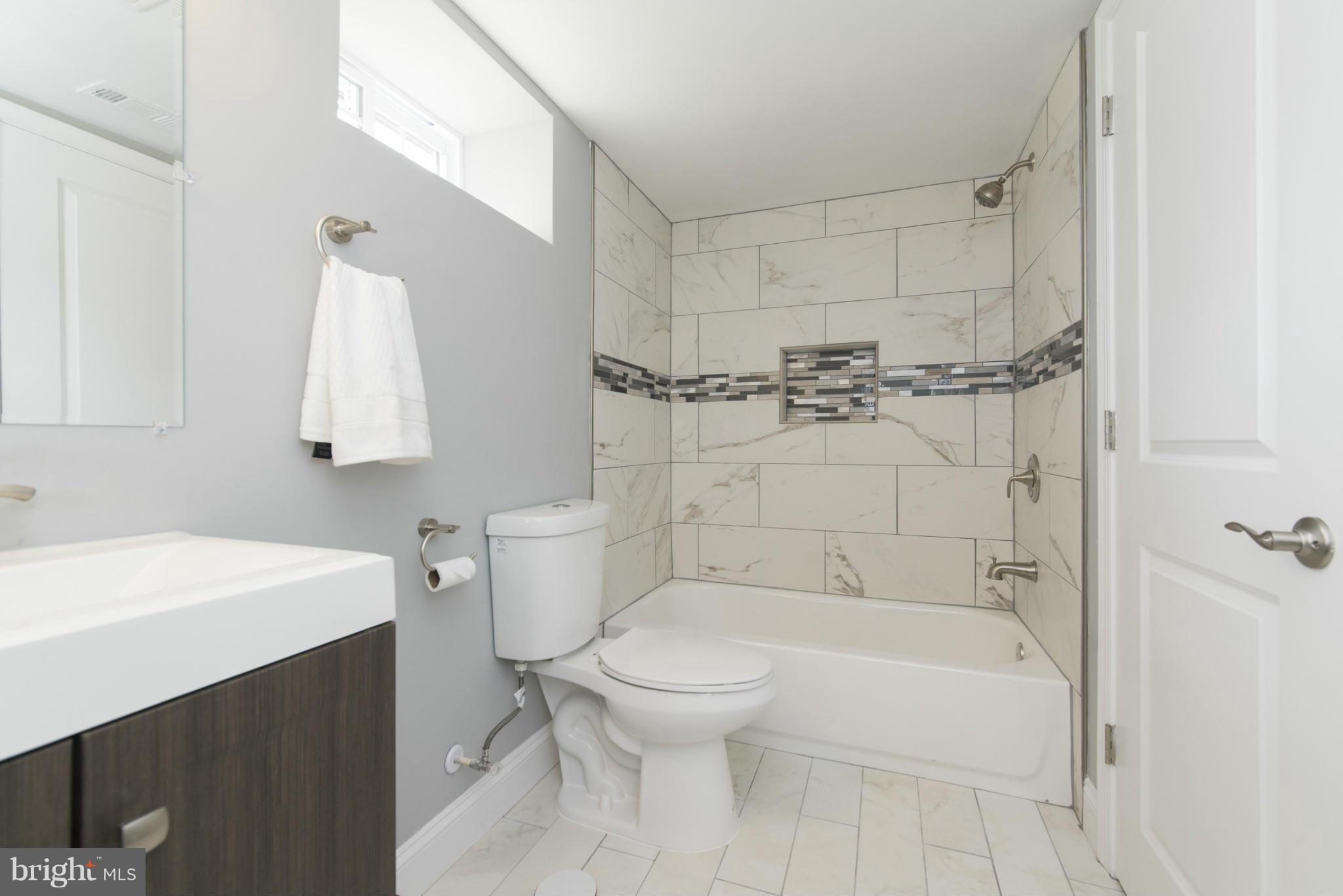6705 Fordcrest Road Baltimore, MD 21237 - Photo 17 of 30 a bathroom with a sink toilet and shower