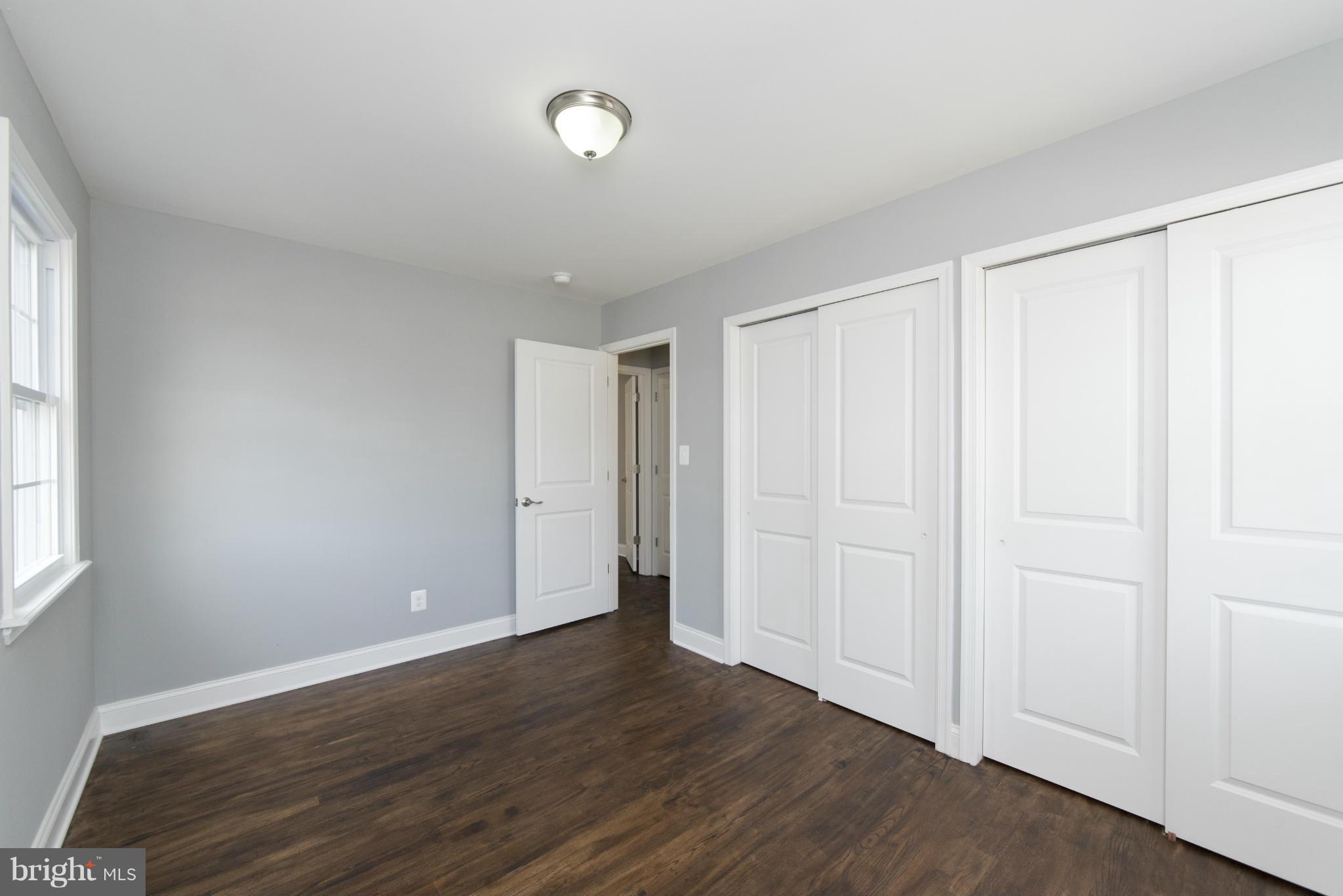 6705 Fordcrest Road Baltimore, MD 21237 - Photo 20 of 30 an empty room with wooden floor and windows