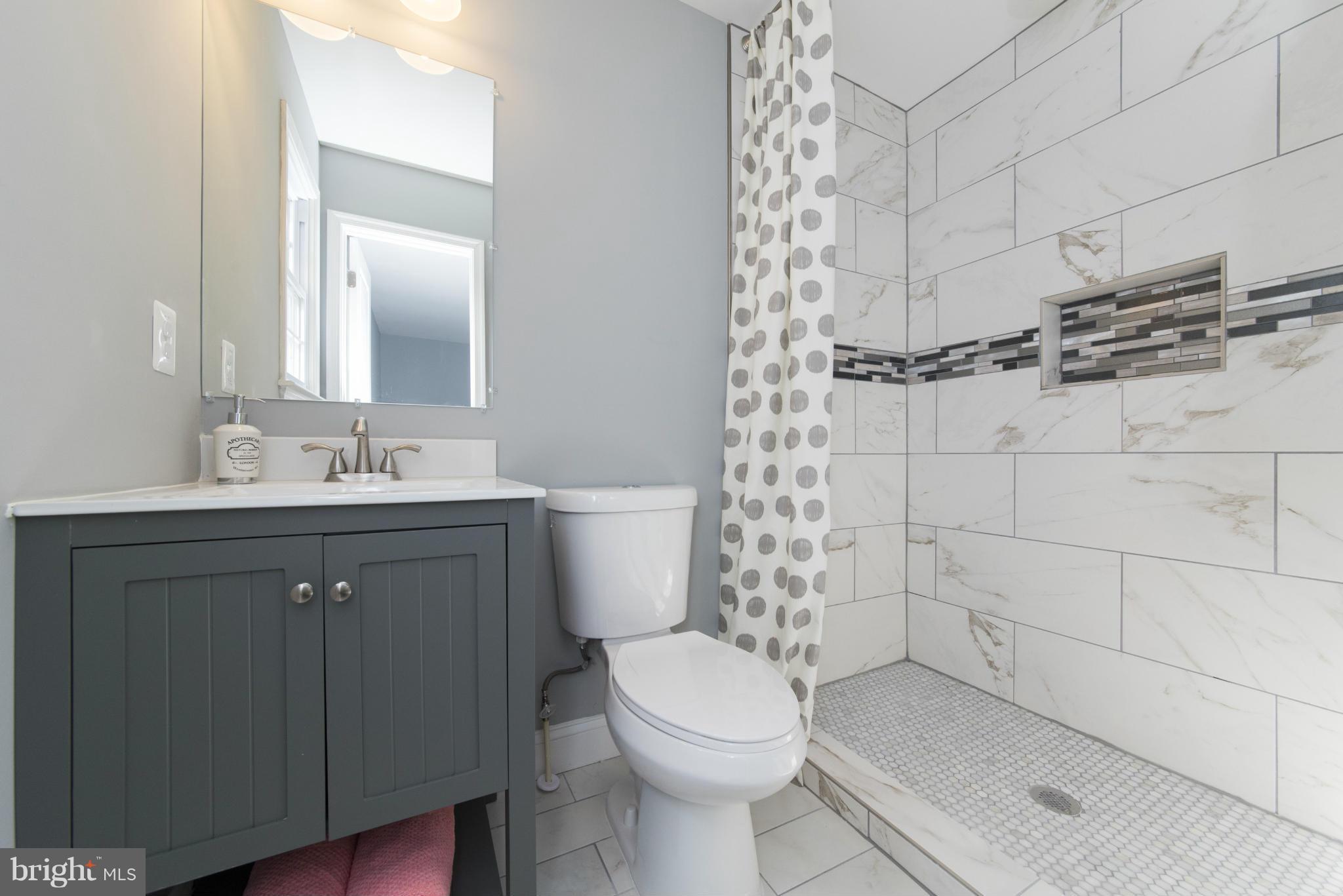 6705 Fordcrest Road Baltimore, MD 21237 - Photo 26 of 30 a bathroom with a sink a toilet and shower