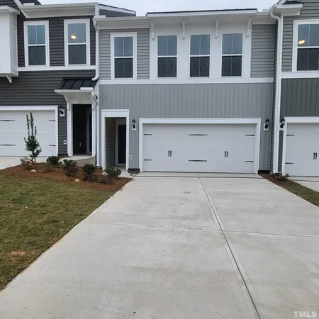 front view of a brick house with a yard