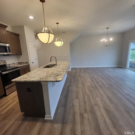 a view of kitchen with cabinets and wooden floor