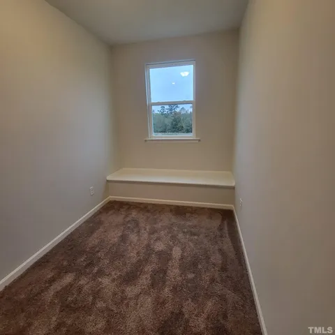 an empty room with a empty space and windows