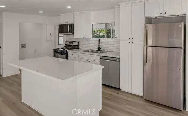 a kitchen with a stove and a sink