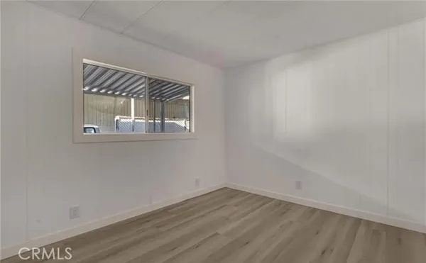 a view of a hallway with wooden floor and entryway