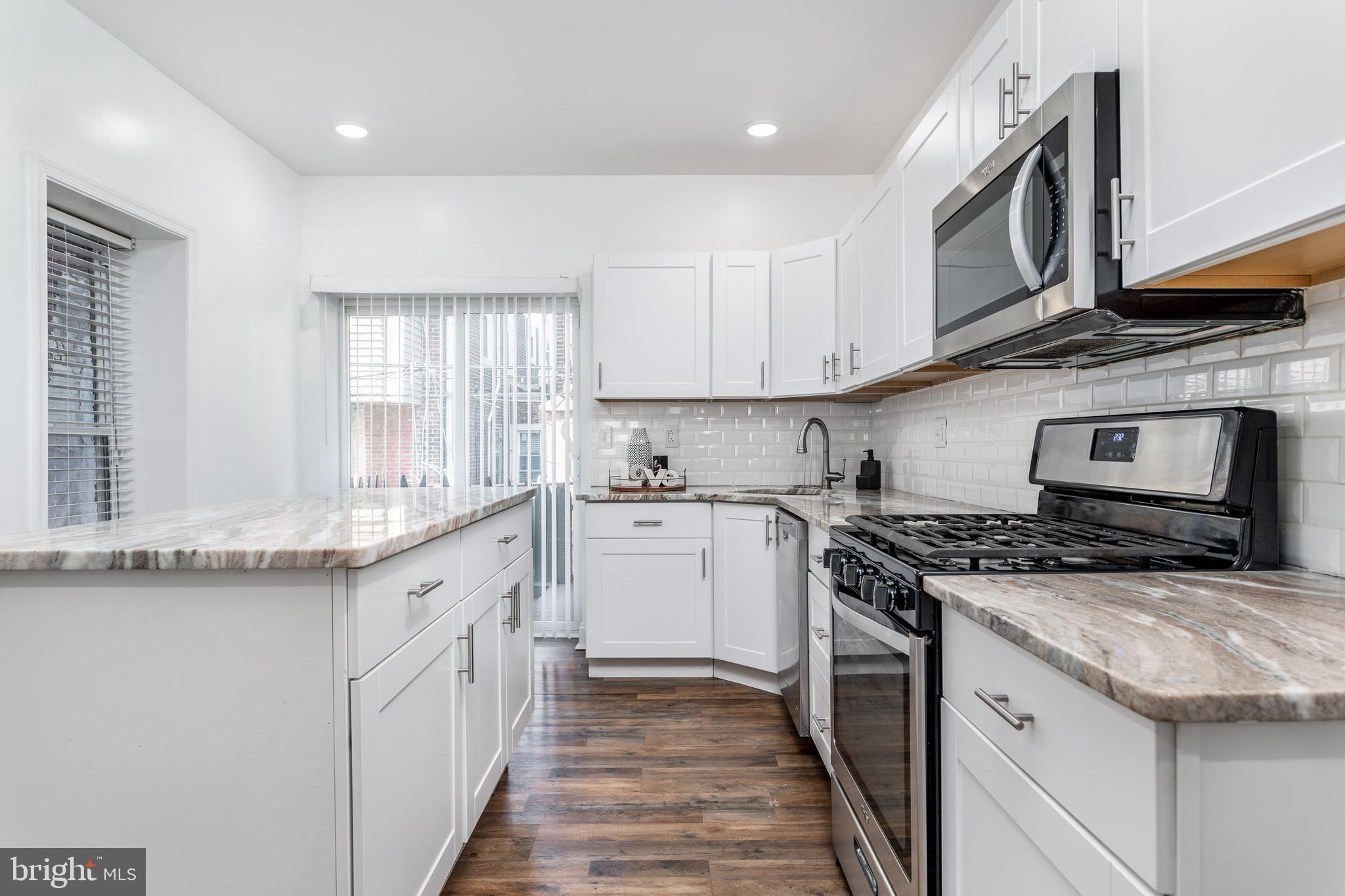1639 North Corlies Street Philadelphia, PA 19121 - Photo 4 of 20 a kitchen with stainless steel appliances granite countertop a stove and a sink