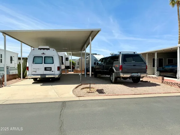 a front view of a house with a yard and potted plants