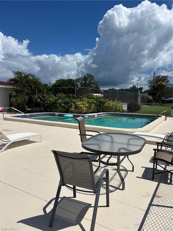 3250 10th Street North, Unit A8 Naples, FL 34103 - Photo 11 of 13 a view of a chairs and table in the terrace
