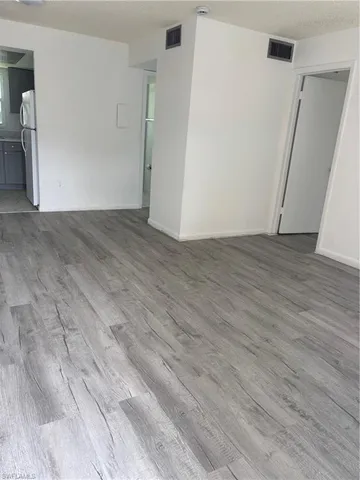 an empty room with wooden floor