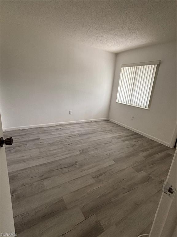 3250 10th Street North, Unit A8 Naples, FL 34103 - Photo 7 of 13 a view of an empty room and window