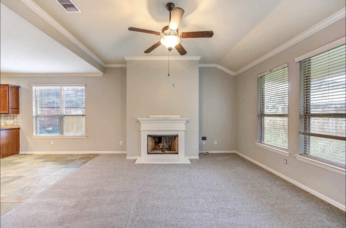 7 Maple Mill Court Conroe, TX 77301 - Photo 17 of 49 a view of an empty room with window and fireplace