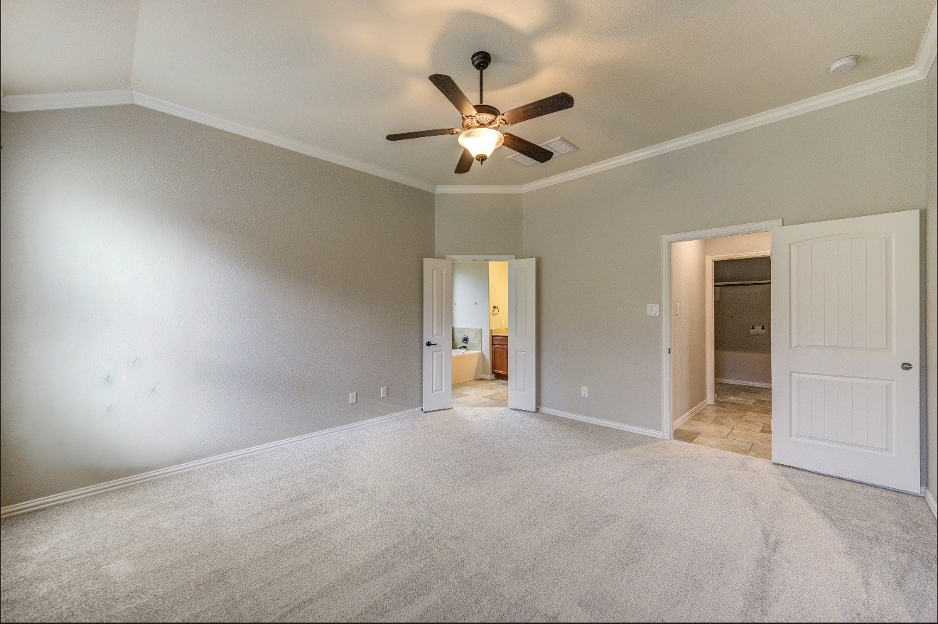7 Maple Mill Court Conroe, TX 77301 - Photo 25 of 49 a view of a livingroom with a ceiling fan and window