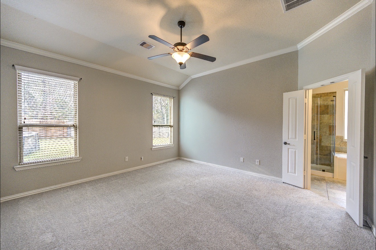 7 Maple Mill Court Conroe, TX 77301 - Photo 27 of 49 a view of a livingroom with a ceiling fan and window