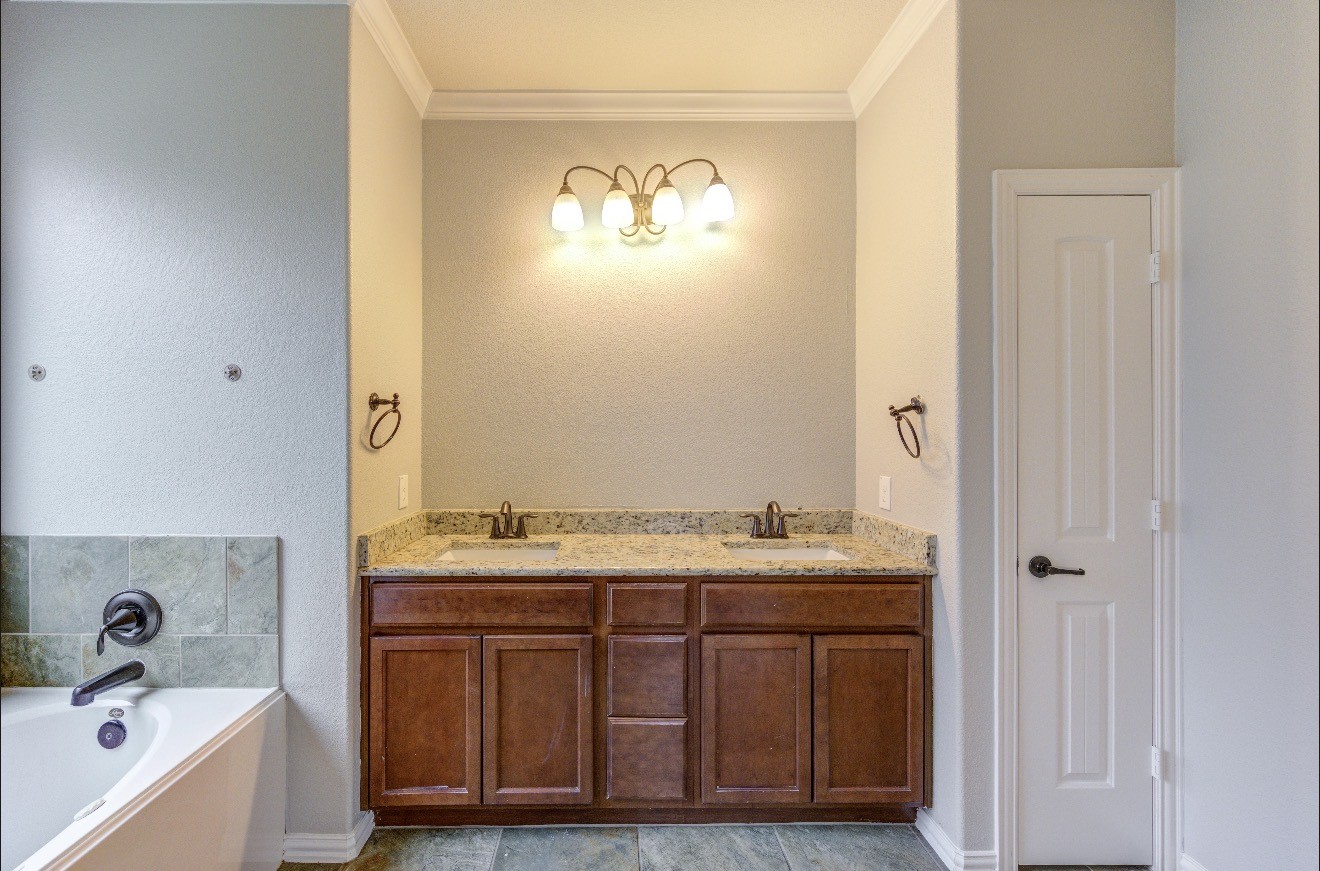 7 Maple Mill Court Conroe, TX 77301 - Photo 28 of 49 a bathroom with a sink and a mirror