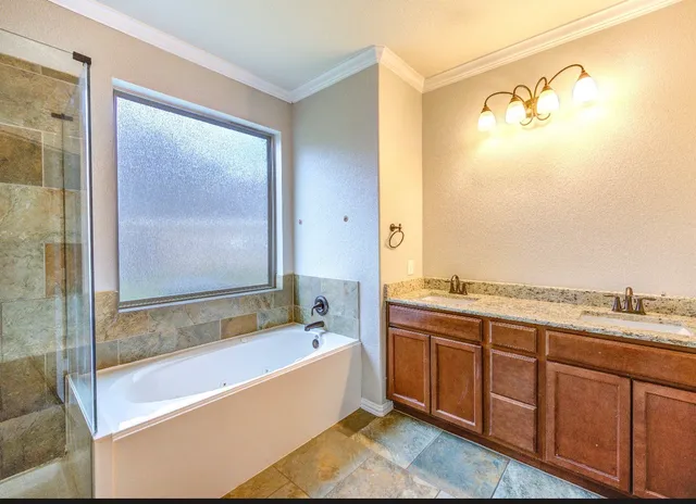 a bathroom with a bathtub and a shower