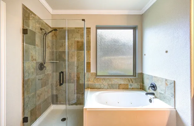 a bathroom with a tub sink and mirror