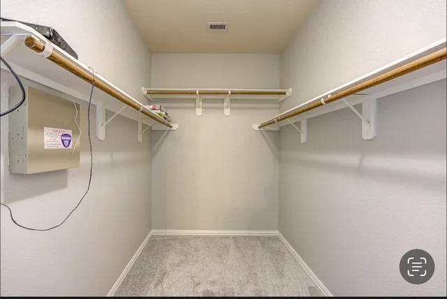 an empty room with ceiling fan and window