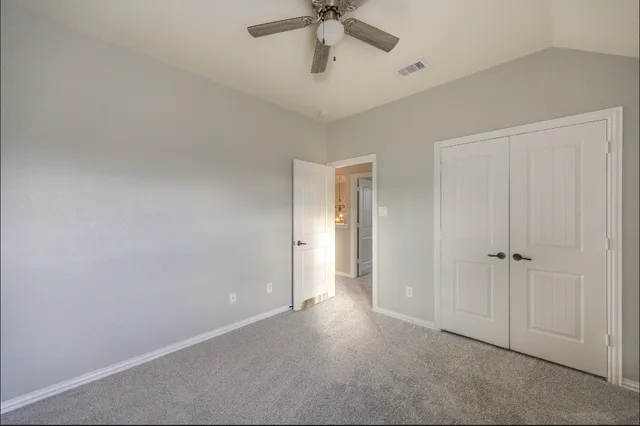 a front view of a house with a garden and yard