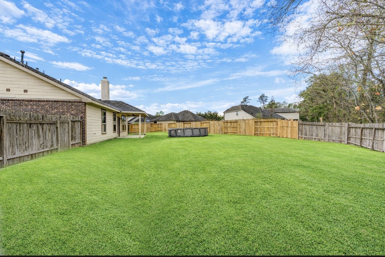 7 Maple Mill Court Conroe, TX 77301 - Photo 48 of 49 a view of a house with backyard and garden