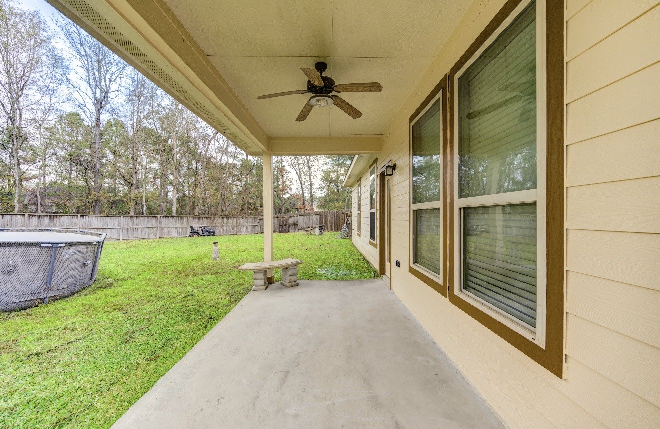 7 Maple Mill Court Conroe, TX 77301 - Photo 49 of 49 a view of a porch with a backyard