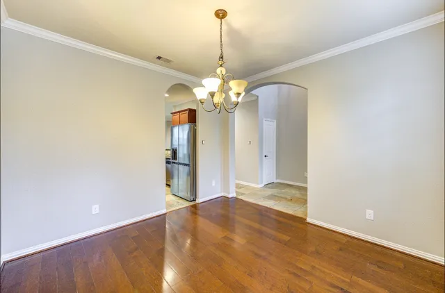 a view of a chandelier in big room and a chandelier