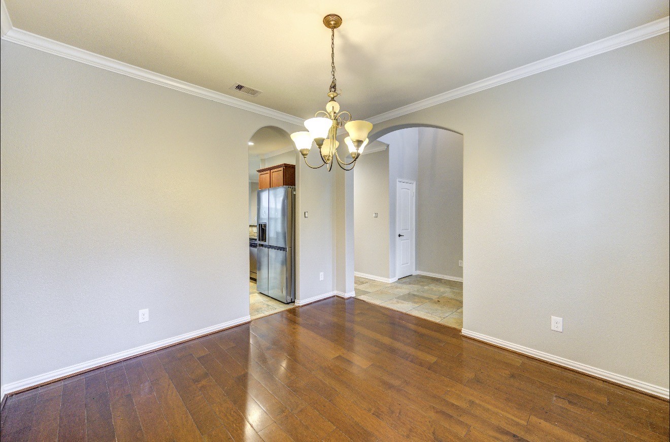 7 Maple Mill Court Conroe, TX 77301 - Photo 6 of 49 a view of a chandelier in big room and a chandelier