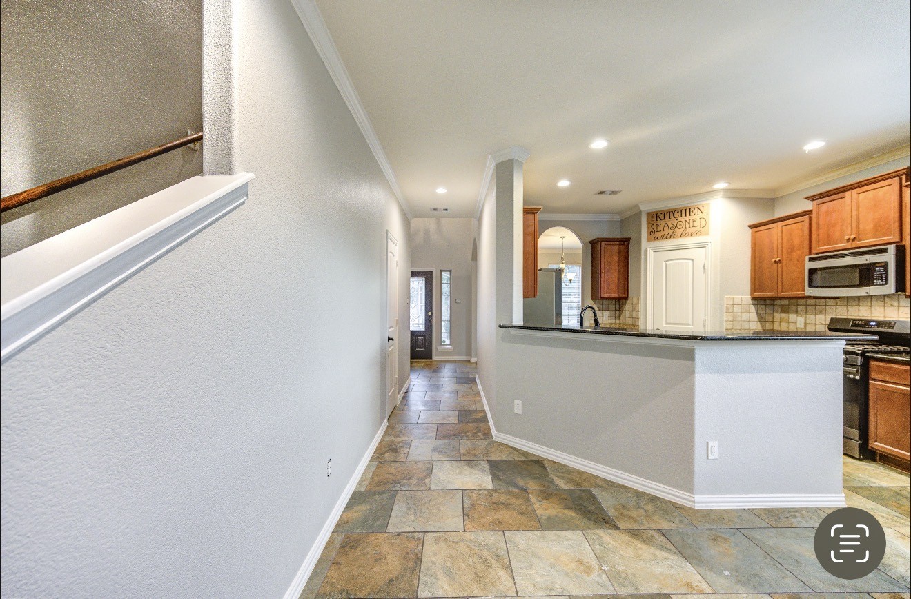 7 Maple Mill Court Conroe, TX 77301 - Photo 9 of 49 a view of a kitchen with a sink and a refrigerator