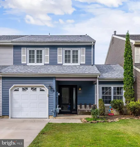 a front view of house with yard outdoor seating and garage