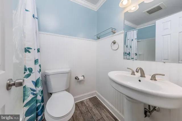 a white toilet sitting next to a bathroom sink