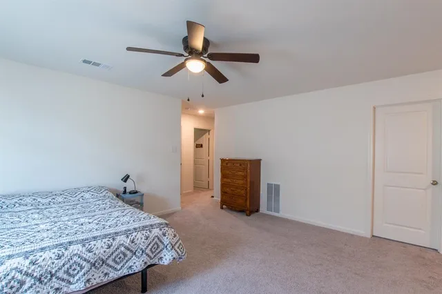 a bedroom with a bed and cabinets