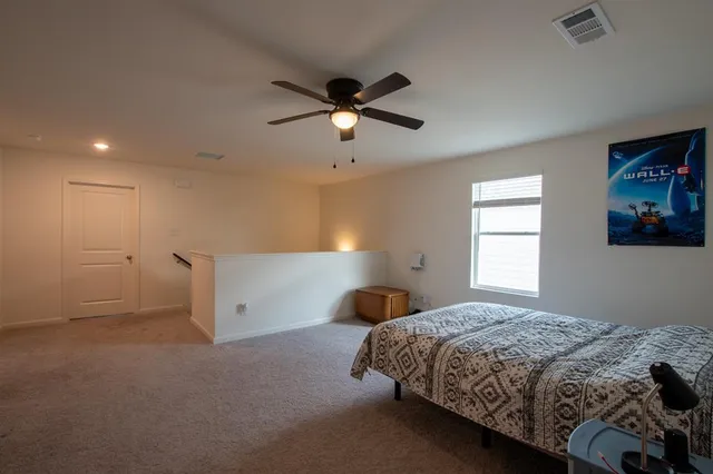 a bedroom with a bed and a window