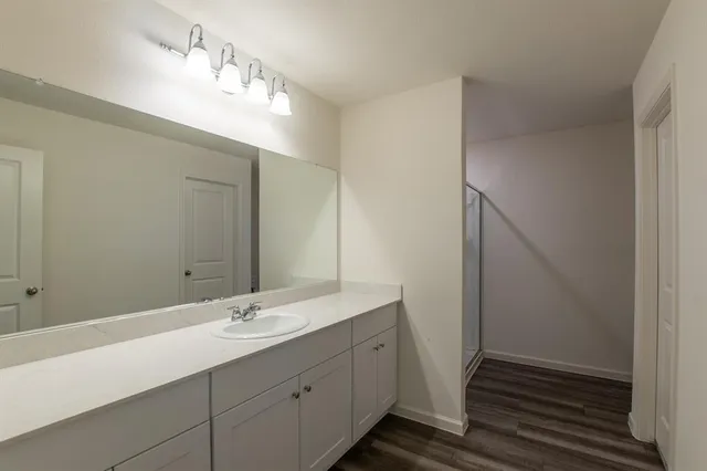 a bathroom with a double vanity sink and a mirror