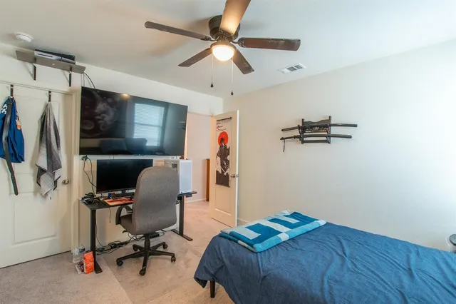 a bedroom with a workspace