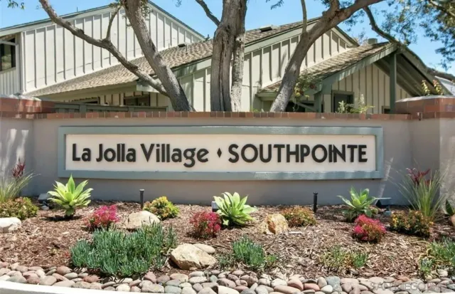 a sign broad in front of flowers