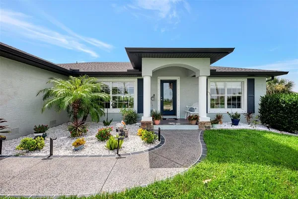 a view of a house with backyard sitting area and garden