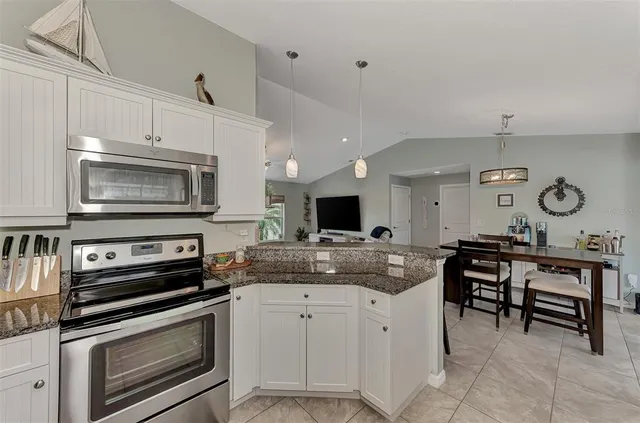 a kitchen with a stove and a microwave