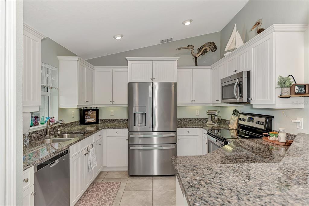 8 Amidship Road Placida, FL 33946 - Photo 14 of 47 a kitchen with a refrigerator sink and stainless steel appliances