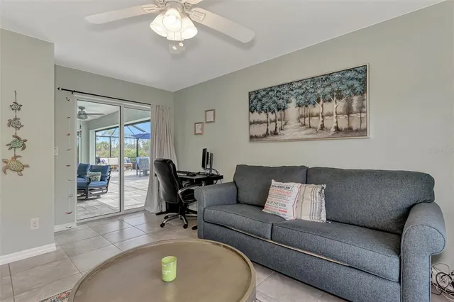 a living room with furniture a window and a flat screen tv