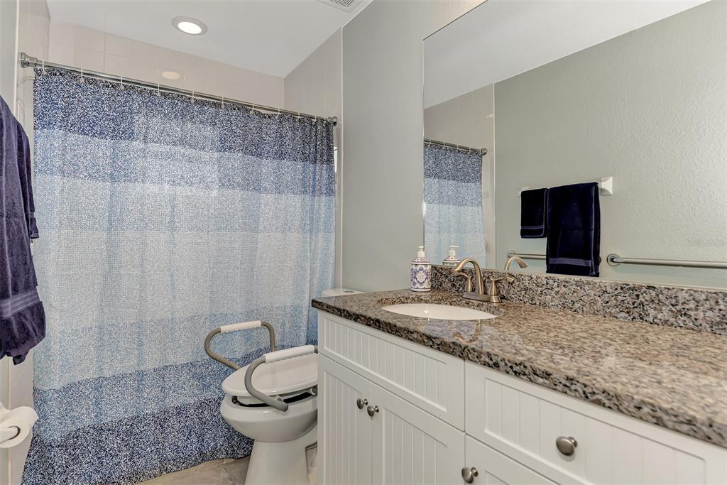 8 Amidship Road Placida, FL 33946 - Photo 30 of 47 a bathroom with a granite countertop sink a toilet and a mirror