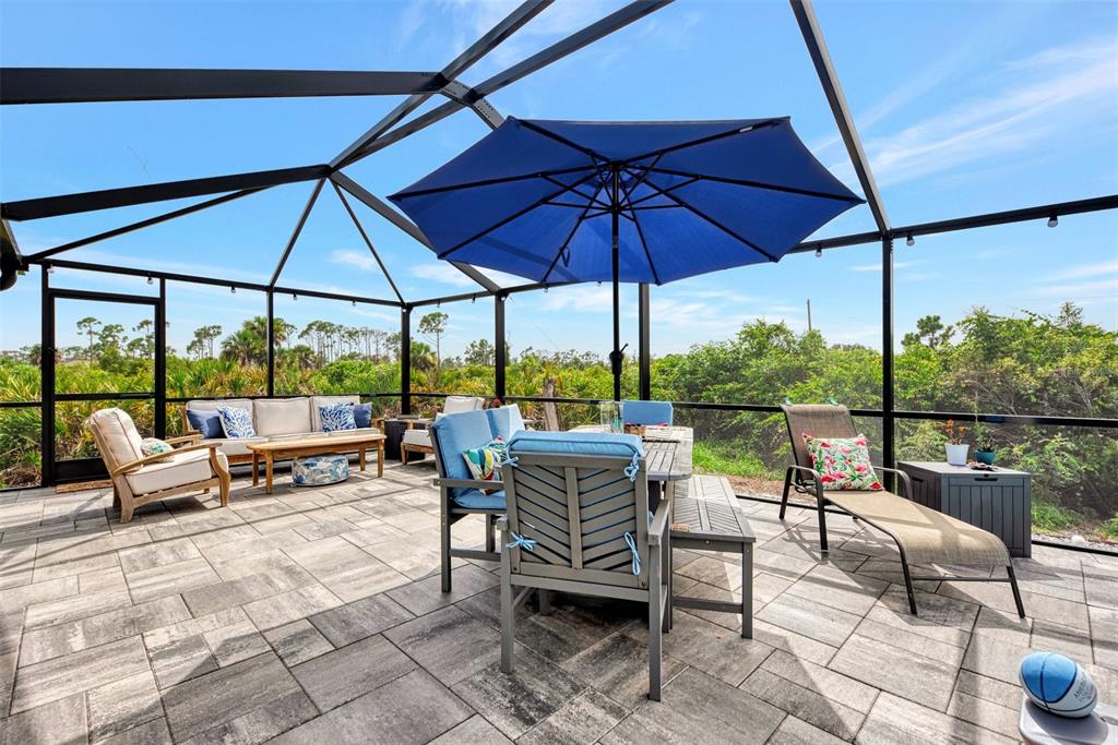 8 Amidship Road Placida, FL 33946 - Photo 37 of 47 a view of a patio with a table and chairs under an umbrella