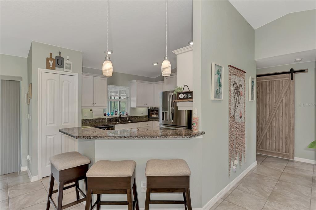 8 Amidship Road Placida, FL 33946 - Photo 10 of 47 a kitchen with stainless steel appliances granite countertop a sink and a refrigerator