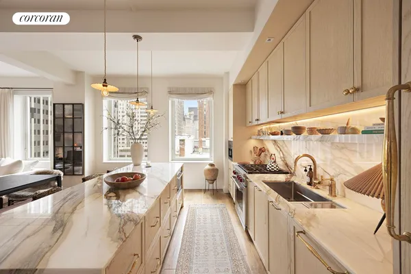 a kitchen with granite countertop a sink and white cabinets