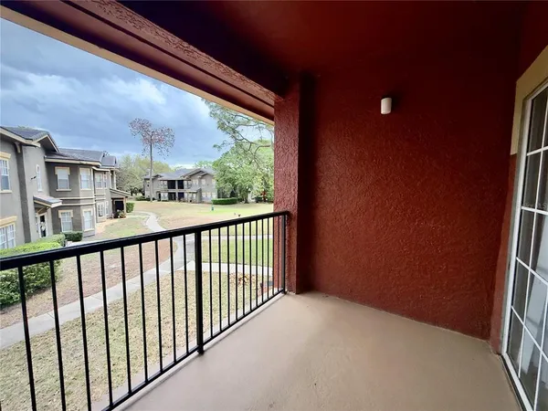 a balcony view with a large window