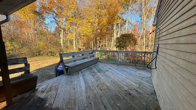 a view of a balcony with wooden floor and outdoor space
