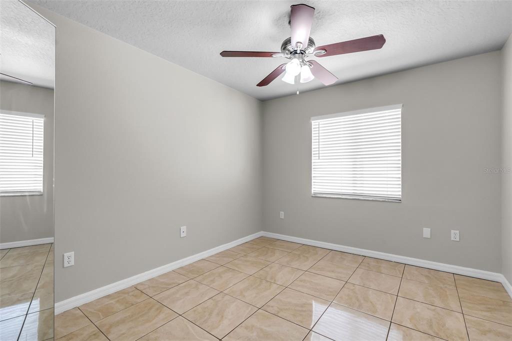 1424 Ocean Reef Road Wesley Chapel, FL 33544 - Photo 16 of 47 a view of an empty room with windows